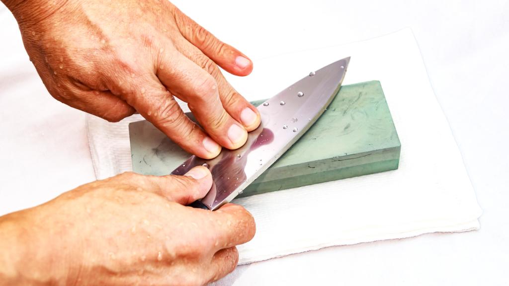 Honing Chef Knife/Close up of hand working Japanese chef knife