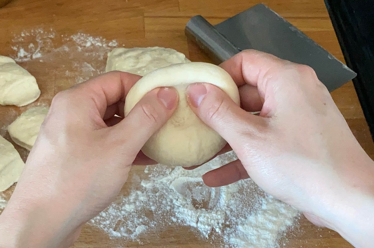 Pre-shaping the balls into discs. (Photo: Allie Chanthorn Reinmann)