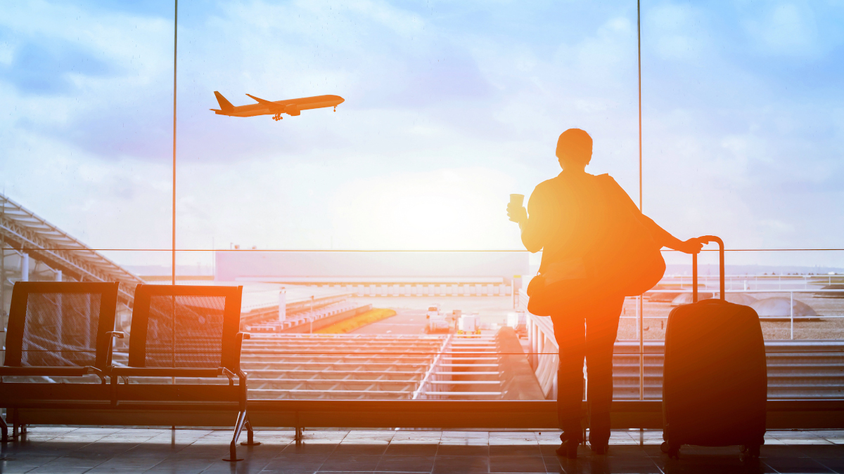 happy traveler waiting for the flight in airport