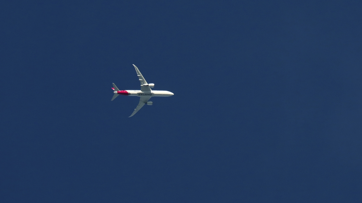 Qantas Airplane Flies Over New York City at Sunset