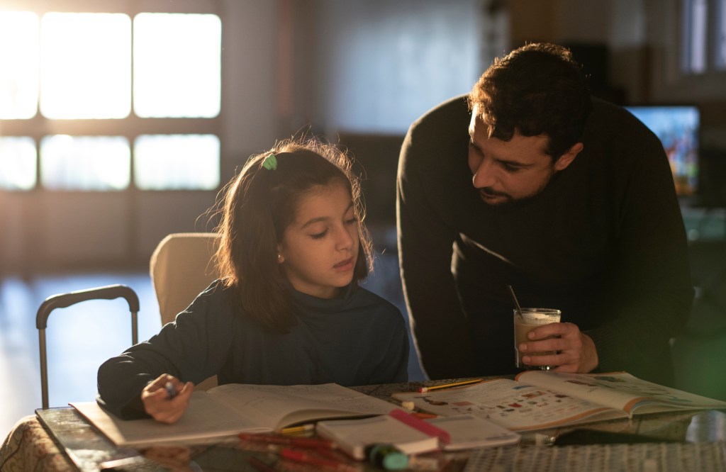 father and daughter do homework together at home